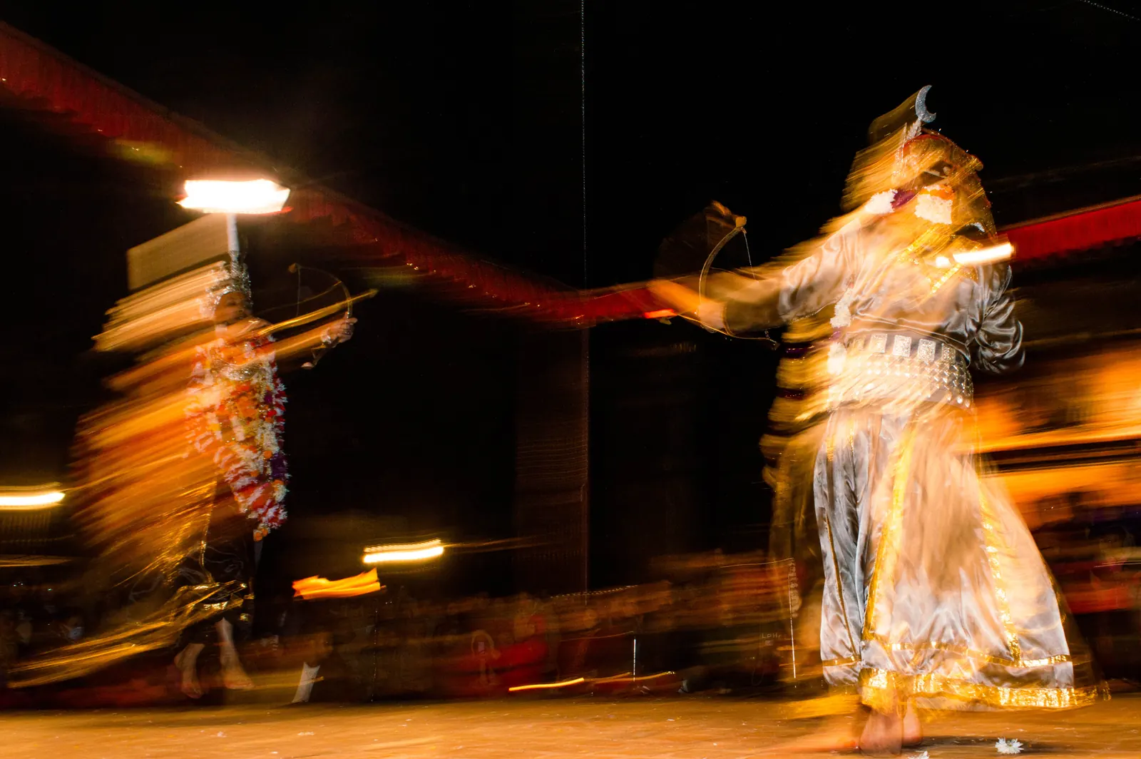 Dancers spinning at night, blurred with movement
